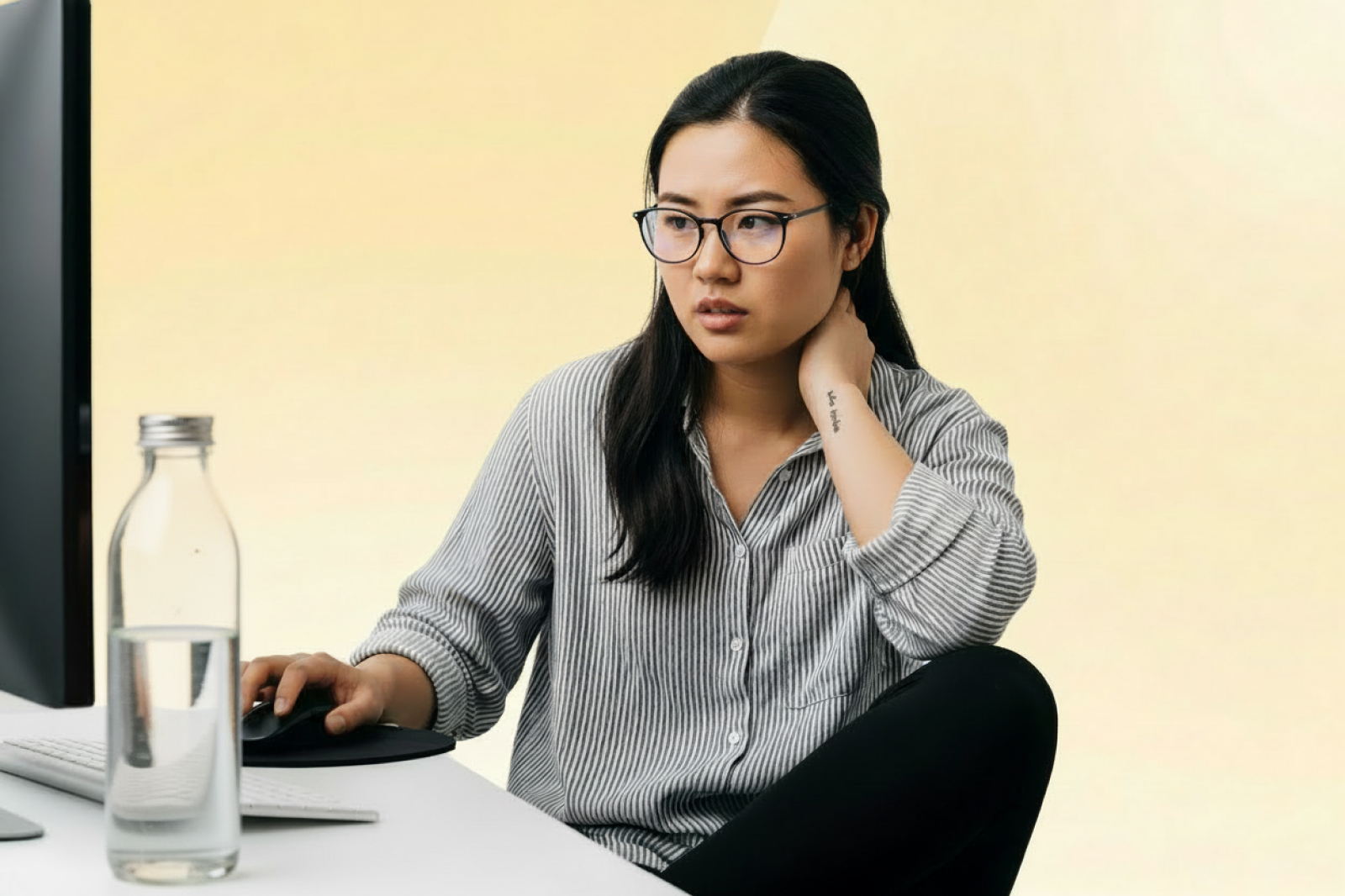 Working professional stretching to ease neck and back stiffness at a desk